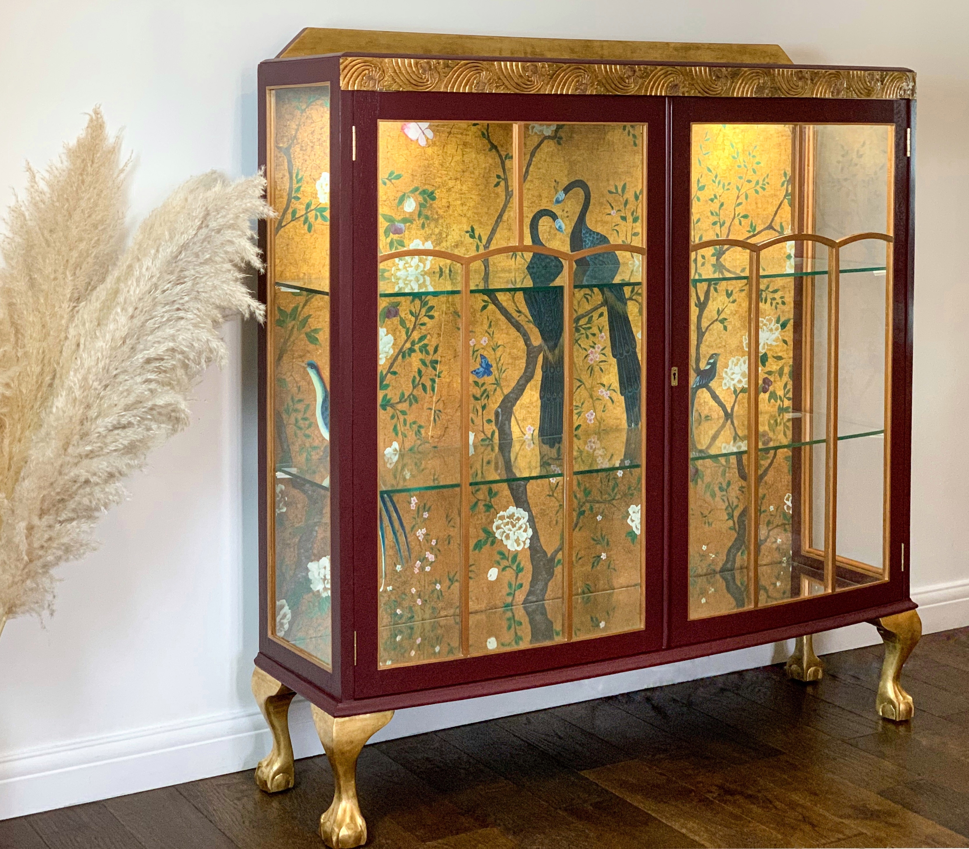 A vintage glass cocktail cabinet